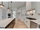 Spacious kitchen with marble countertops, stainless steel appliances, and a dark brown island at 4090 Sandy Lake Dr, Lithonia, GA 30038