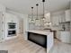 Bright kitchen features a large island with marble countertop, stainless steel appliances, and white cabinetry at 4090 Sandy Lake Dr, Lithonia, GA 30038