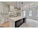 Bright kitchen features an island with marble countertop, stainless steel appliances, and adjacent dining area at 4090 Sandy Lake Dr, Lithonia, GA 30038