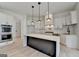 Bright kitchen features a large island with marble countertop, stainless steel appliances, and white cabinetry at 4090 Sandy Lake Dr, Lithonia, GA 30038