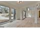 Bright living room features large windows, light wood floors, and an open floor plan at 4090 Sandy Lake Dr, Lithonia, GA 30038