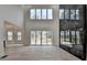 Bright, open living room with a fireplace, large windows, and access to an outdoor deck at 4090 Sandy Lake Dr, Lithonia, GA 30038