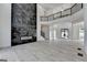 Open-concept living area with modern fireplace and staircase to the upper level at 4090 Sandy Lake Dr, Lithonia, GA 30038