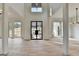 Bright, expansive living room boasting soaring ceilings, wood floors, and a modern glass-paneled front door at 4090 Sandy Lake Dr, Lithonia, GA 30038
