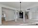 Open-concept living area features light wood floors and an elegant light fixture for modern living at 4090 Sandy Lake Dr, Lithonia, GA 30038