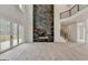 Spacious living room featuring a modern fireplace and access to the home's upper level at 4090 Sandy Lake Dr, Lithonia, GA 30038