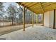 Covered concrete patio overlooking a spacious yard with a pond view at 4090 Sandy Lake Dr, Lithonia, GA 30038