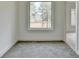 Cozy room featuring carpeted floors and a large window with a view at 4090 Sandy Lake Dr, Lithonia, GA 30038