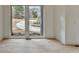 Bright room with wood floors and a view of a winding driveway through a large window at 4090 Sandy Lake Dr, Lithonia, GA 30038
