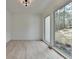 Sun-drenched room with wood floors and a large window offering serene outdoor views at 4090 Sandy Lake Dr, Lithonia, GA 30038