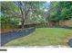 Expansive backyard featuring manicured lawn, mature trees, and landscaping for outdoor enjoyment at 1042 Faith Se Ave, Atlanta, GA 30316