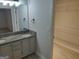 Well-lit bathroom with double sinks, granite countertops, and a large mirror, plus a walk-in closet for storage at 17 Brittany Ne Way, Atlanta, GA 30324