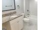 Bathroom features a granite countertop vanity, updated fixtures, and a tub with white tile surround at 17 Brittany Ne Way, Atlanta, GA 30324