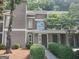 Exterior view of a two-story unit featuring nice landscaping with green bushes and a walkway at 17 Brittany Ne Way, Atlanta, GA 30324