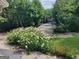 Lush landscaped grounds with white flowers, leading to a parking area at 17 Brittany Ne Way, Atlanta, GA 30324