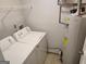 Utility area featuring a washer, dryer, and hot water heater at 17 Brittany Ne Way, Atlanta, GA 30324