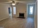 Open-concept living room with fireplace, neutral paint, and new flooring at 17 Brittany Ne Way, Atlanta, GA 30324