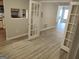 Bright living room featuring wood-look floors and french doors, connecting to the kitchen through an opening at 17 Brittany Ne Way, Atlanta, GA 30324