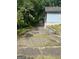 Long driveway leads to potential outbuildings with a home with light blue siding at 702 Emily Nw Pl # 0, Atlanta, GA 30318