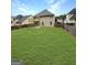 Large, green backyard with wooden fence. A wooden deck overlooks the yard, perfect for outdoor enjoyment at 120 Hawken Trl, Mcdonough, GA 30253