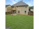 Expansive backyard with a wooden deck and fence, a patio, and lush green grass, perfect for outdoor activities at 120 Hawken Trl, Mcdonough, GA 30253