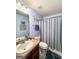 Light and bright bathroom features a vanity with a faux marble top and blue striped shower curtain at 120 Hawken Trl, Mcdonough, GA 30253