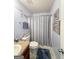 A well-lit bathroom with decorative artwork and a shower/tub at 120 Hawken Trl, Mcdonough, GA 30253