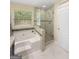 A soaking tub and a walk-in shower with glass surround at 120 Hawken Trl, Mcdonough, GA 30253
