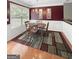 Cozy dining room with a wooden table, area rug, and natural light from a window at 120 Hawken Trl, Mcdonough, GA 30253