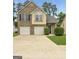 Elegant two-story home with brick accents, a two-car garage, and verdant landscaping at 120 Hawken Trl, Mcdonough, GA 30253