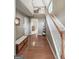 Spacious foyer with hardwood floors, staircase, and view into the living room at 120 Hawken Trl, Mcdonough, GA 30253