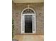 Elegant front entrance featuring a black door with sidelights and overhead transom window at 120 Hawken Trl, Mcdonough, GA 30253