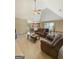 Inviting living room with vaulted ceiling, ceiling fan, and views into the dining room at 120 Hawken Trl, Mcdonough, GA 30253