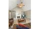 Open living area with a fireplace, comfortable seating, and a ceiling fan at 120 Hawken Trl, Mcdonough, GA 30253