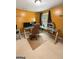 Bright home office features mustard walls, tan carpet, and a desk with storage unit and computer at 120 Hawken Trl, Mcdonough, GA 30253