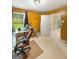 The home office features neutral carpet, mustard walls, a window and a desk with computer at 120 Hawken Trl, Mcdonough, GA 30253