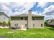 View of the home's back exterior, featuring a spacious backyard with an outdoor hot tub at 1849 Wanda Way, Ellenwood, GA 30294