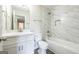 This bright bathroom has tile shower walls, a tub, and marble countertops at 1849 Wanda Way, Ellenwood, GA 30294