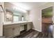 Bathroom featuring double vanity with marble countertops, complemented by sleek fixtures and wood flooring at 1849 Wanda Way, Ellenwood, GA 30294