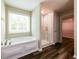 Bright bathroom with a soaking tub, glass-enclosed shower, and a separate entrance to walk-in closet at 1849 Wanda Way, Ellenwood, GA 30294