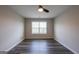 This is an empty bedroom with a window and ceiling fan at 1849 Wanda Way, Ellenwood, GA 30294