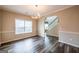 Bright dining room featuring hardwood floors, modern lighting fixture, and easy access to the staircase at 1849 Wanda Way, Ellenwood, GA 30294