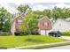 View of the property with lush green lawn, mature trees, and a brick facade in a beautiful neighborhood at 1849 Wanda Way, Ellenwood, GA 30294