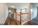 Upstairs hallway boasting vinyl flooring, white trim, and access to other rooms at 1849 Wanda Way, Ellenwood, GA 30294