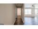 Hallway featuring wood flooring that leads into a living room area, creating a smooth transition throughout the house at 1849 Wanda Way, Ellenwood, GA 30294