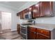 Kitchen featuring stainless steel microwave and oven with dark wood cabinets at 1849 Wanda Way, Ellenwood, GA 30294