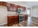Kitchen featuring stainless steel oven, microwave and dark cabinets at 1849 Wanda Way, Ellenwood, GA 30294