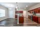 This kitchen has stainless steel appliances, and dark wood cabinets for a sleek look at 1849 Wanda Way, Ellenwood, GA 30294