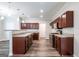 Modern kitchen with rich wood cabinetry, stainless steel appliances, and granite countertops at 1849 Wanda Way, Ellenwood, GA 30294