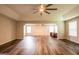 Spacious living room featuring dark vinyl flooring, recessed lighting, and ceiling fans at 1849 Wanda Way, Ellenwood, GA 30294